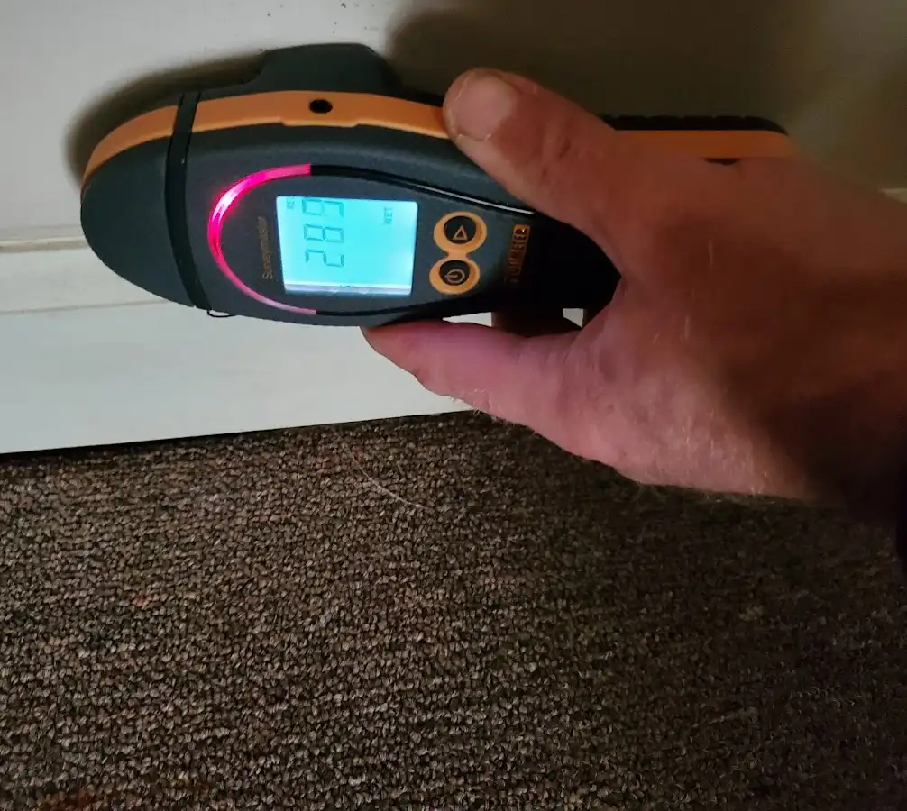 Moisture detection at baseboard during Storm Damage Restoration in Berwick